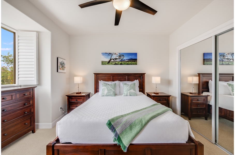 The guest bedroom comes with a queen bed, ceiling fan, and an ensuite bathroom with a shower/tub combo