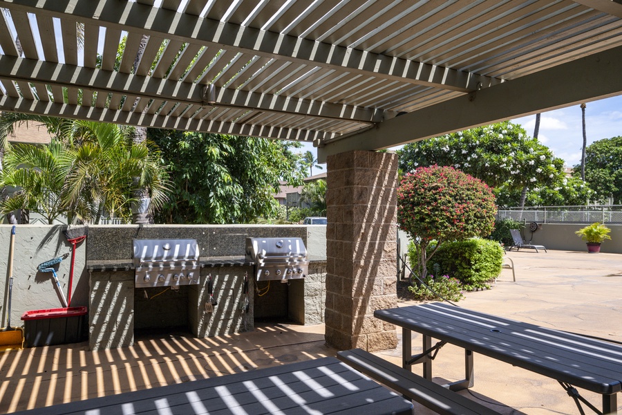 Outdoor kitchen awaits under the pergola, where you'll grill fresh meals while tropical breezes dance through the palms.