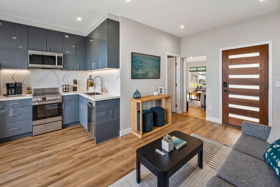 Primary living room off the front door and open to the kitchen.