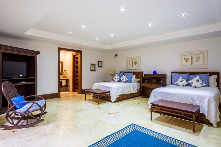 The guest bedroom offers two queen-sized beds.