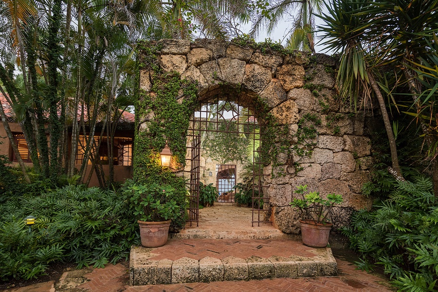 Stone archway leading into the inviting garden area.