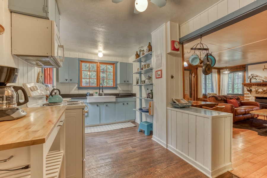 The retro kitchen is fully equipped with all the culinary tools needed to cook up some delicious food, including a fully stocked pantry and an eclectic old-school popcorn maker