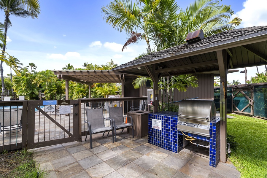 Fire up the grill and savor outdoor cooking in this tropical BBQ pavilion, where palm trees sway overhead and poolside memories are made.