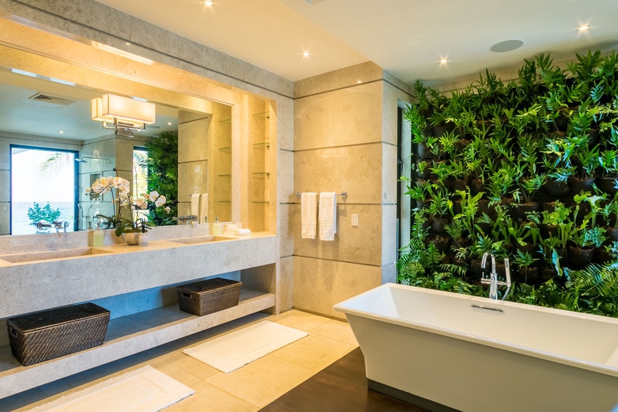 Spacious ensuite bathroom with a luxurious bathtub, dual vanities, and a stunning vertical garden.