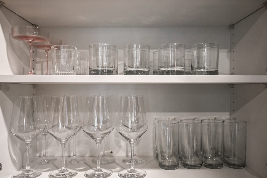 Enjoy your favorite beverages with a full selection of glasses including wine, water, and cocktail options.