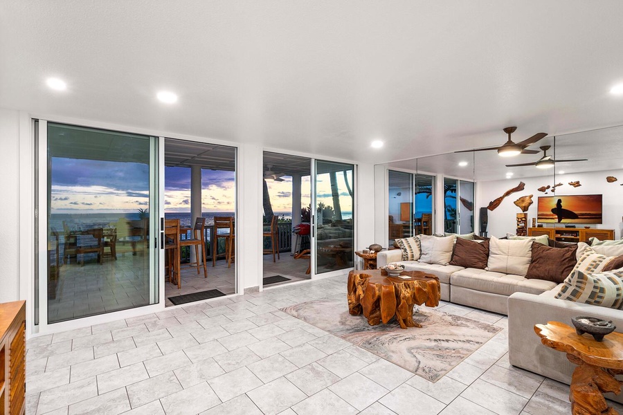 The open concept living, dining and kitchen areas are wrapped with direct access to the lanai.