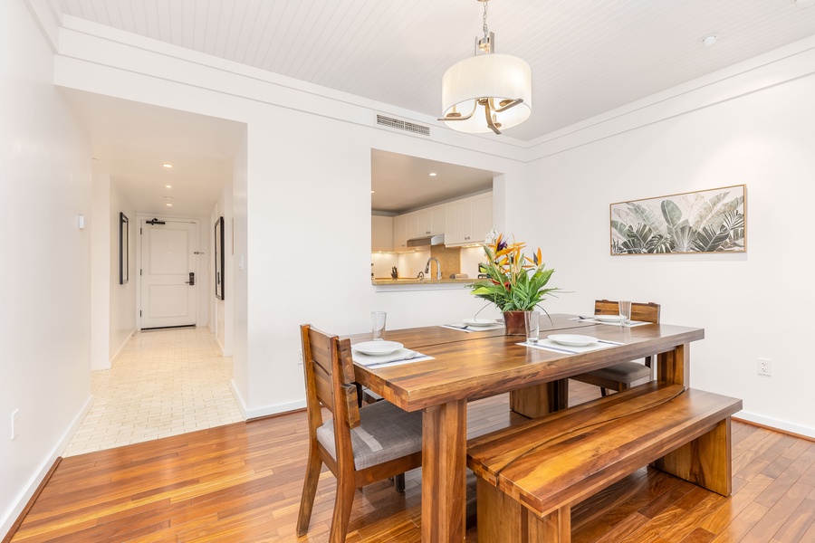 Gather around your elegant dining table with warm wood tones and stylish pendant lighting, creating perfect moments for shared meals.