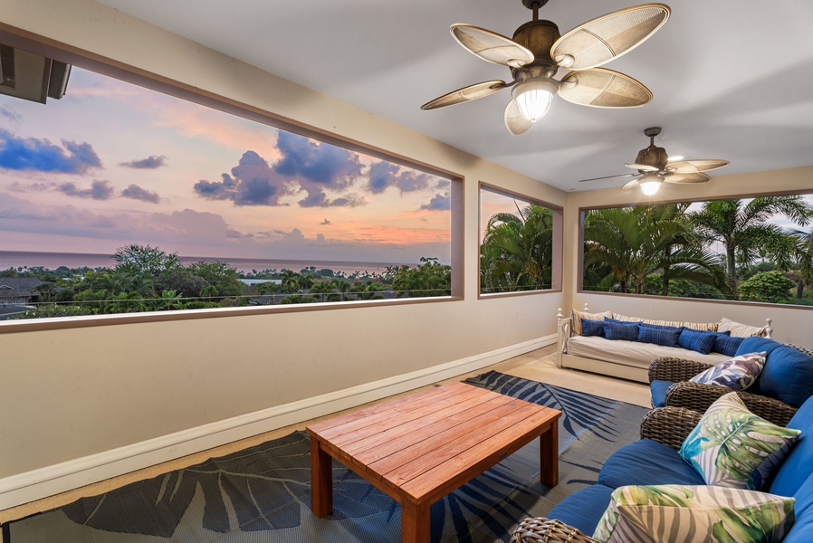 Covered lanai with plush seating and breathtaking views of the lush surroundings.