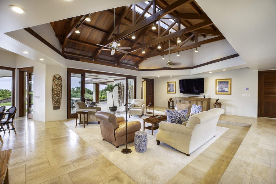 Unwind in this stunning open living space featuring soaring wood beam ceilings, elegant furnishings, and seamless indoor-outdoor flow.