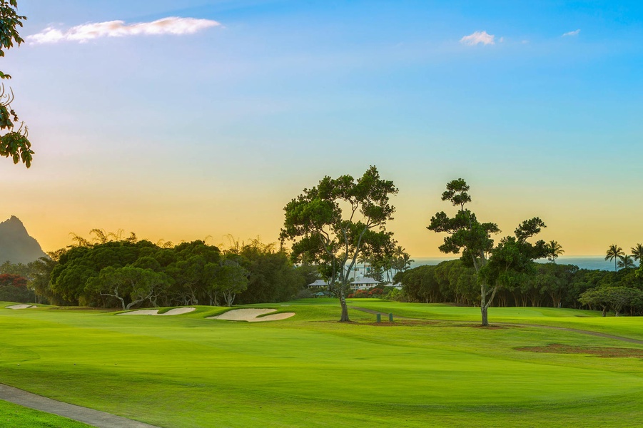 Golf course at golden hour, just steps from the home, offering stunning scenery and leisure.