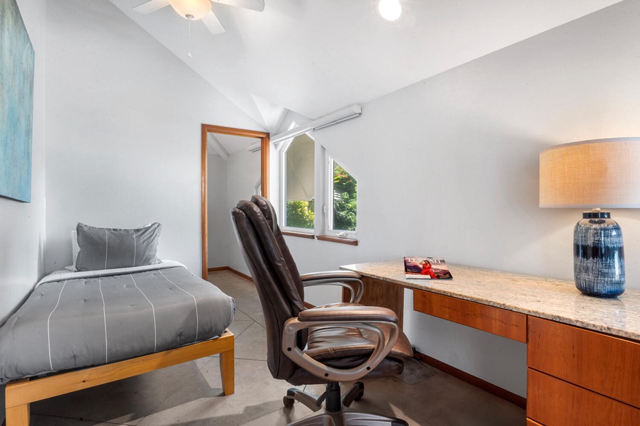 Dedicated home office with ocean peek views, desk, and ergonomic chair—perfect for remote work.