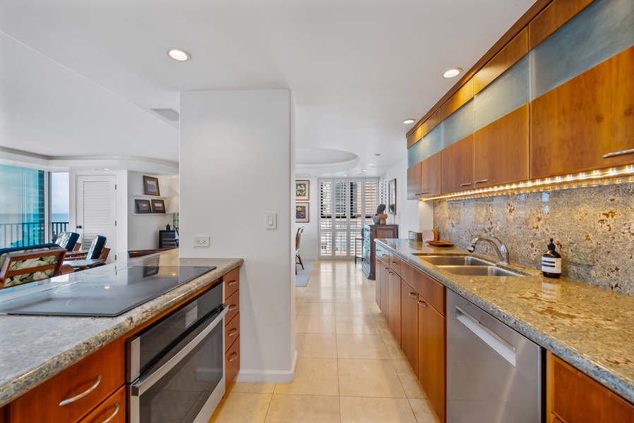 Long, modern kitchen with high-end finishes and plenty of counter space, creating a chef’s dream environment.