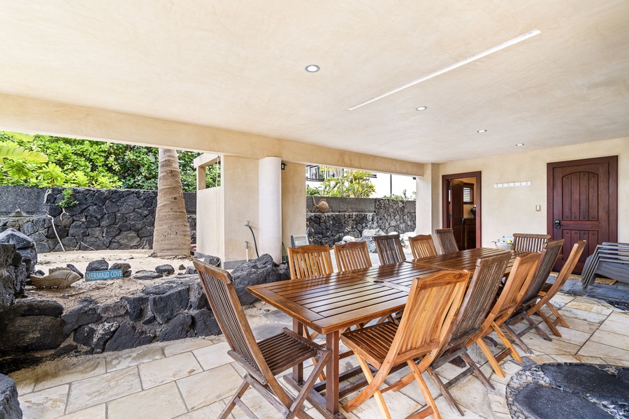 Large outdoor dining table for 10 under covered lanai—gather for breezy meals just steps from the pool.