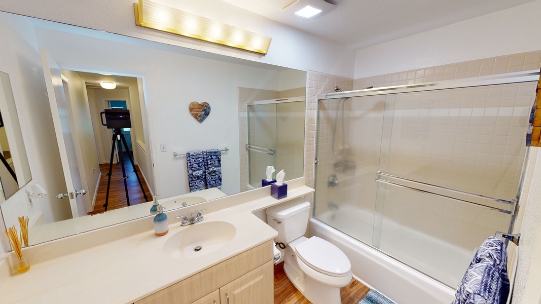 The second guest bathroom has a shower and tub combination.