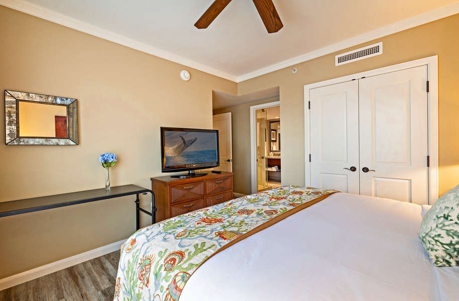 The primary suite in Honua Kai Konea 230/232 features a king bed, smart TV, and private bathroom access