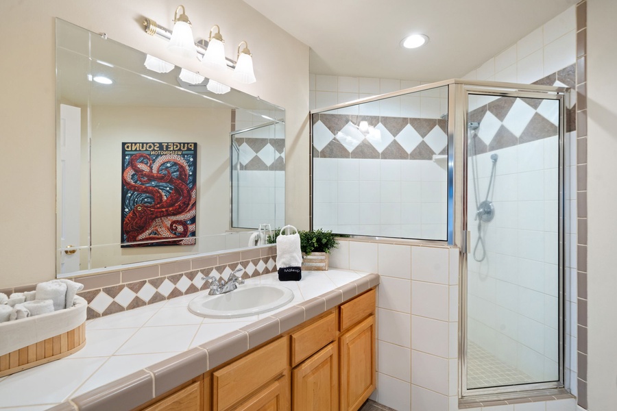 Refresh in your spacious bathroom with elegant tile work, a luxurious soaking tub, and a separate glass shower enclosure.