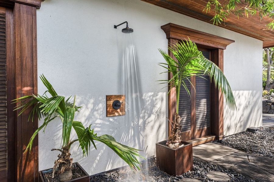 Refresh under your private outdoor shower surrounded by tropical palms and natural beauty.