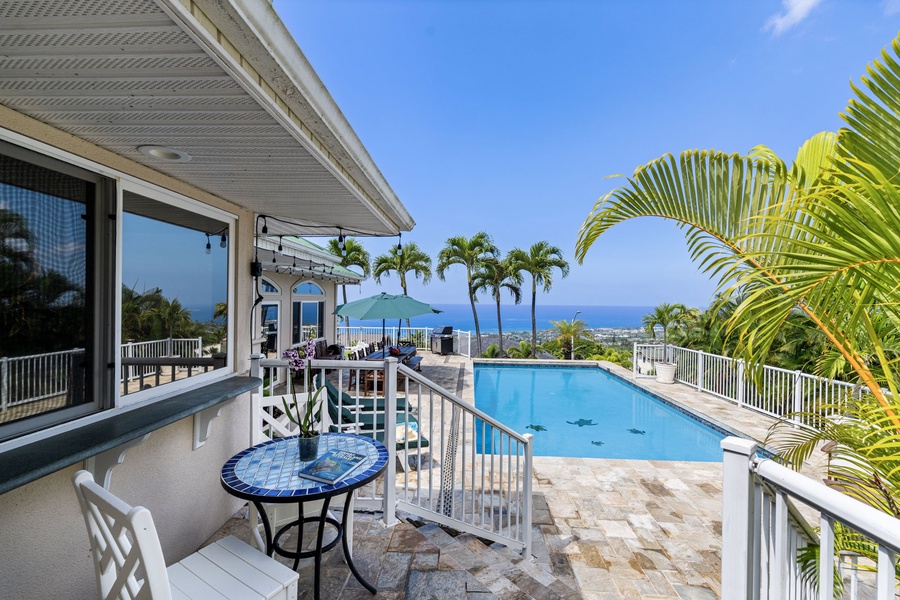 Sip your morning coffee on this tropical lanai while gazing at the sparkling pool and ocean views beyond.
