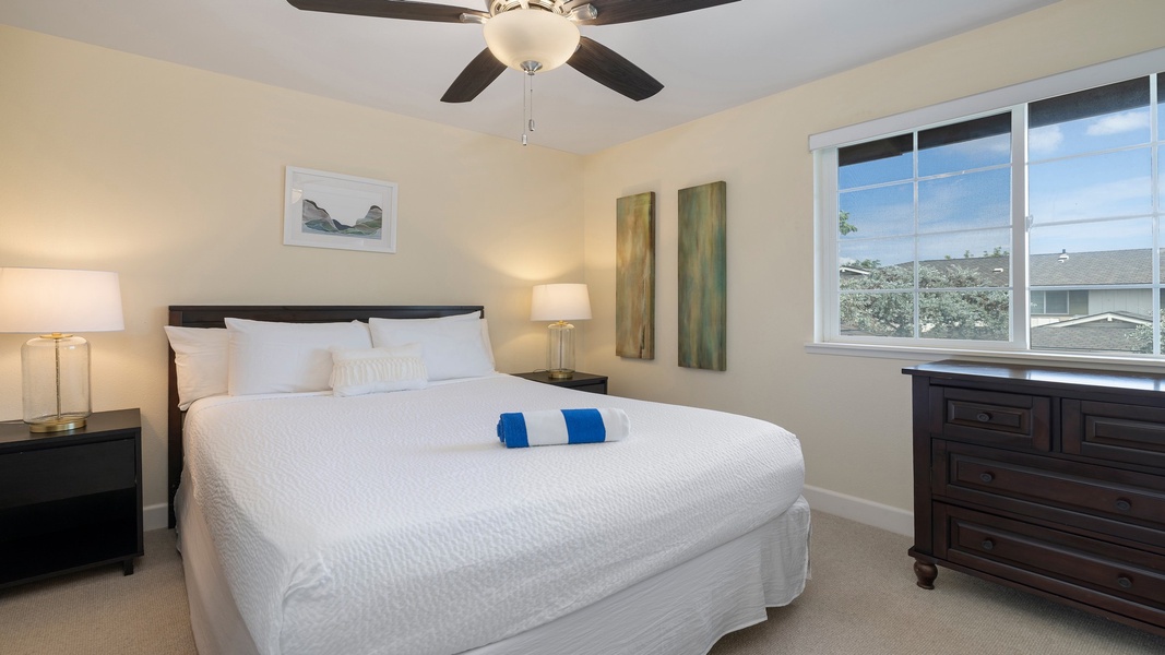 Peaceful and airy, the primary bedroom offers serene views and access to a nearby ensuite, ideal for guests seeking privacy and comfort.