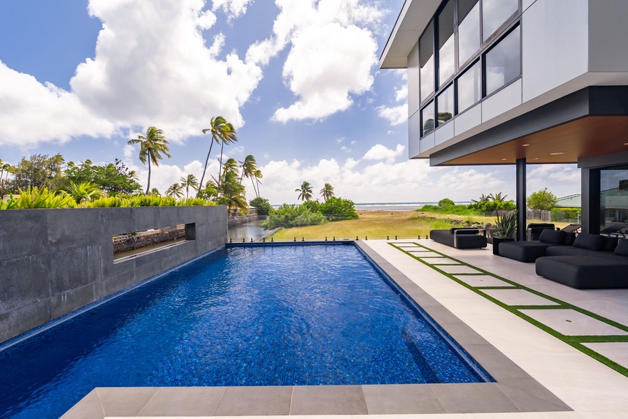 Infinity-edge pool extending toward the horizon with coastal views beyond.