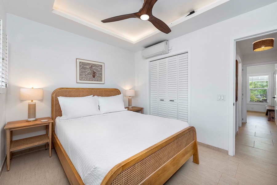 The guest bedroom with split AC, TV, ensuite bath and ceiling fan.