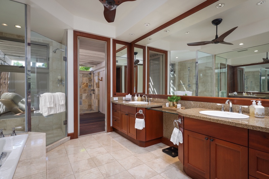Primary ensuite bath with dual vanities, indoor & outdoor shower and private W/C.
