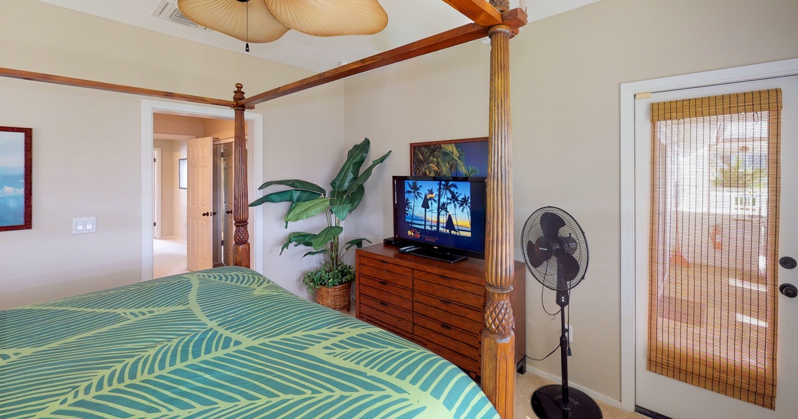 The primary guest bedroom also features a dresser and Polynesian style  furnishings.