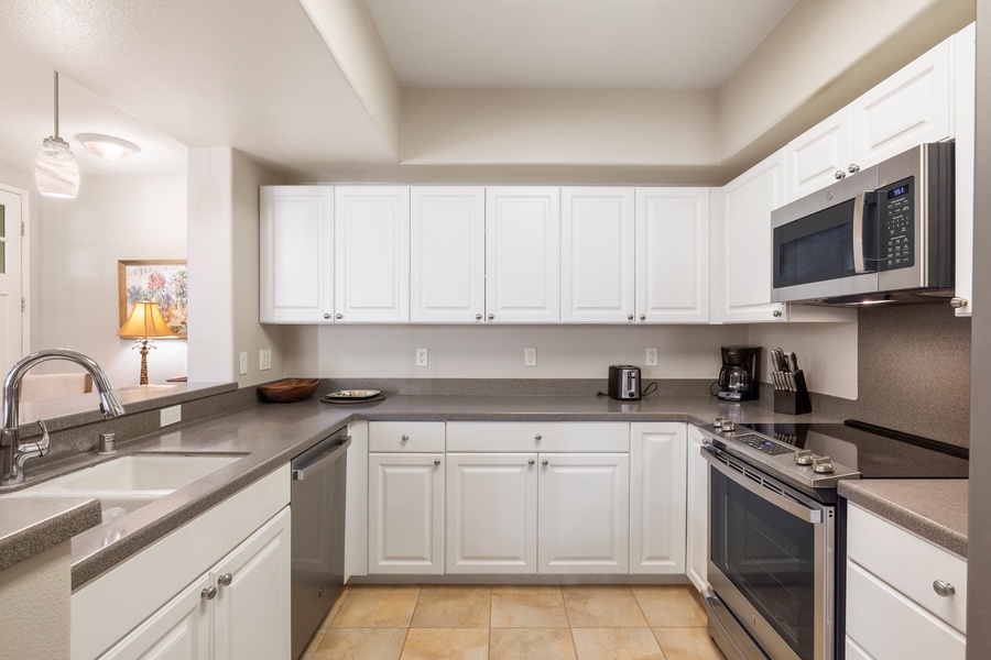 Bright and functional, this modern kitchen includes granite countertops, stainless steel appliances, and everything needed for home-cooked meals.