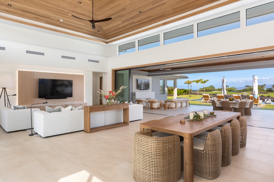 Unwind in your expansive living space where natural wood meets contemporary comfort, opening seamlessly to tropical views.