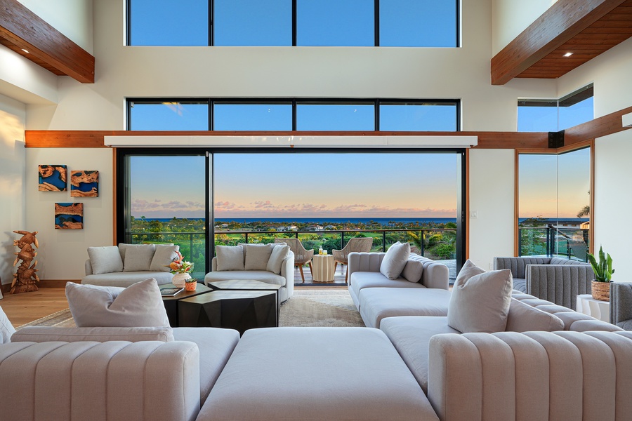 Lounge in luxury with plush seating and floor-to-ceiling windows that frame the breathtaking horizon, inviting the beauty of the sunset into your living space.