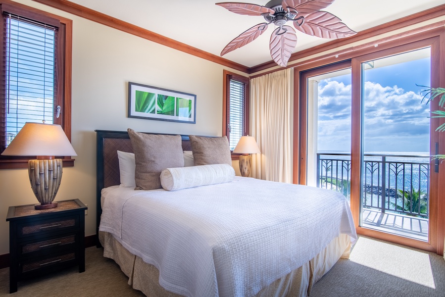 The primary guest bedroom with comfortable linens and lovely vacation views.