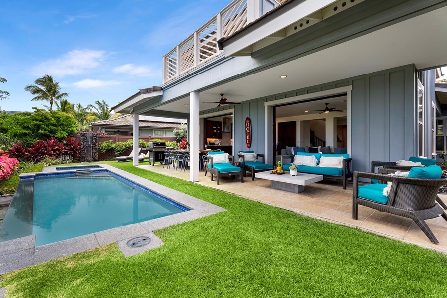 Spacious backyard with a refreshing pool and an inviting open-air lounge area, ideal for both relaxation and entertaining.