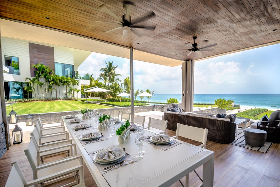 Dine al fresco in this elegant outdoor dining area, complete with ocean views.