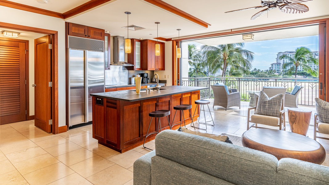 An open floor plan and bar seating in the kitchen.