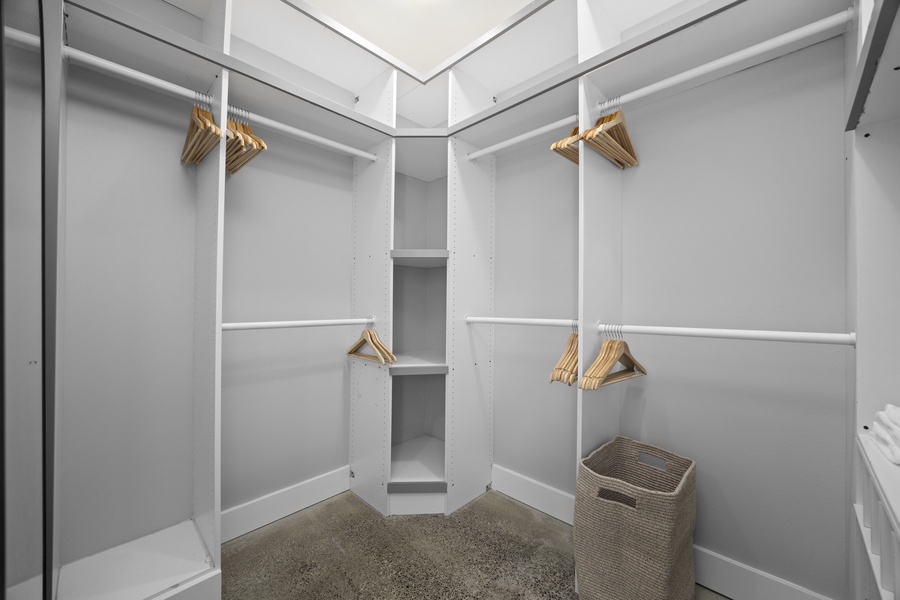Expansive walk-in closet with built-in shelving and skylight — thoughtful touches for extended stays.