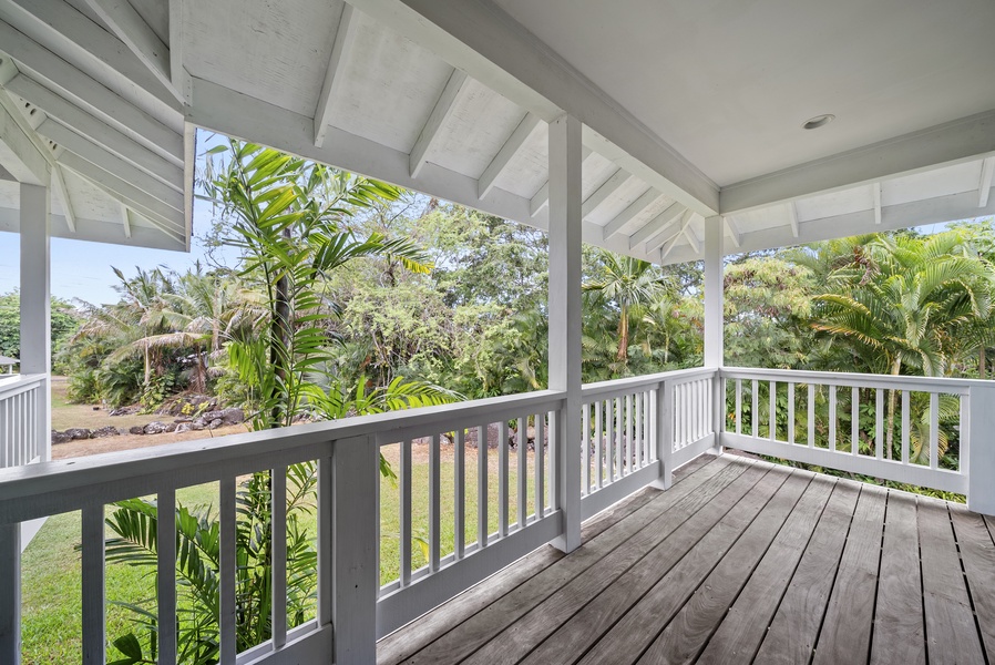 Step outside onto the shaded wraparound lanai, where lush tropical greenery surrounds you. The perfect spot for morning coffee or quiet moments in nature.