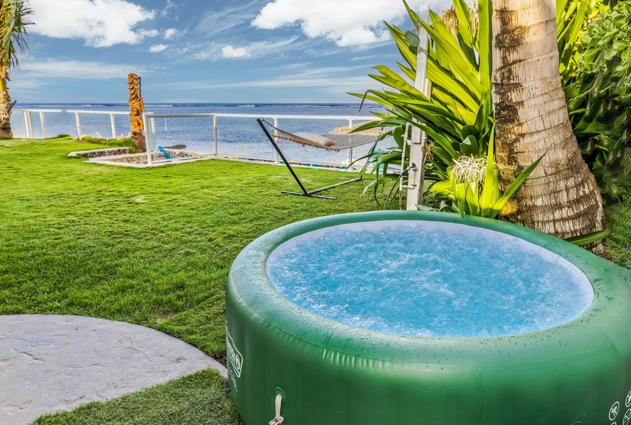 Unwind in your private hot tub surrounded by lush tropical gardens, with the ocean just steps away from your peaceful retreat.