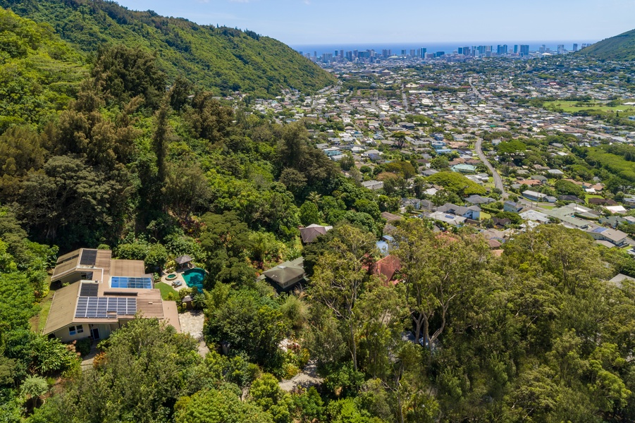 Aerial view reveals the estate’s unmatched location—perched above Honolulu with sweeping views from mountain to ocean.