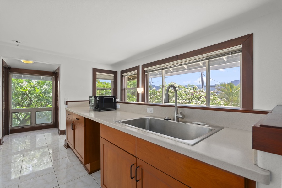 Kitchenette area with sink, counter space, and storage.