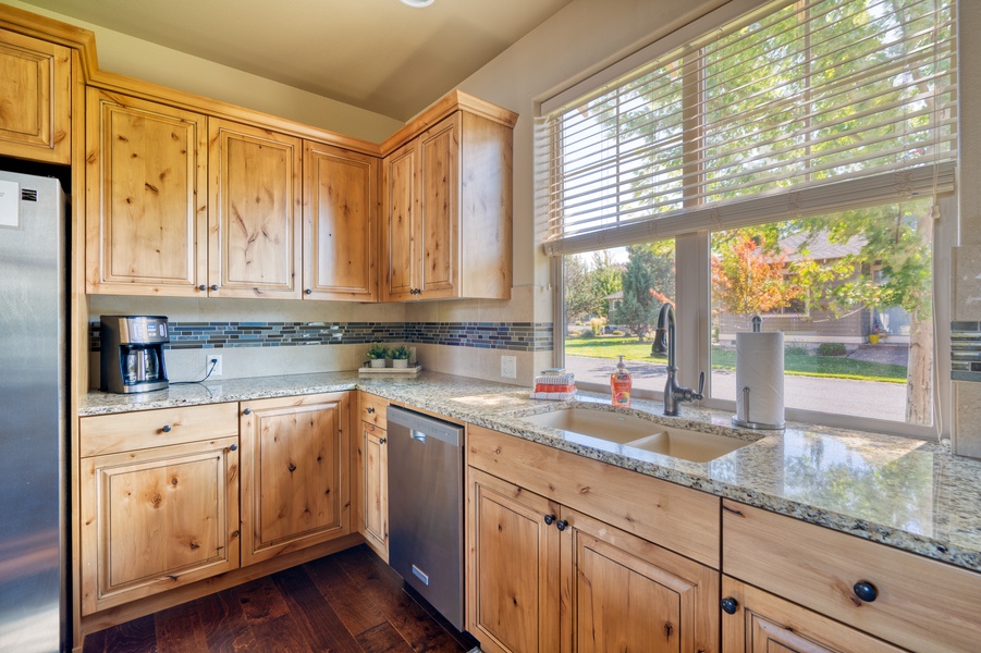 Cleaning up is a breeze with the handy dishwasher, and the window above the sink bathes the area in natural light, adding a touch of brightness to your kitchen tasks