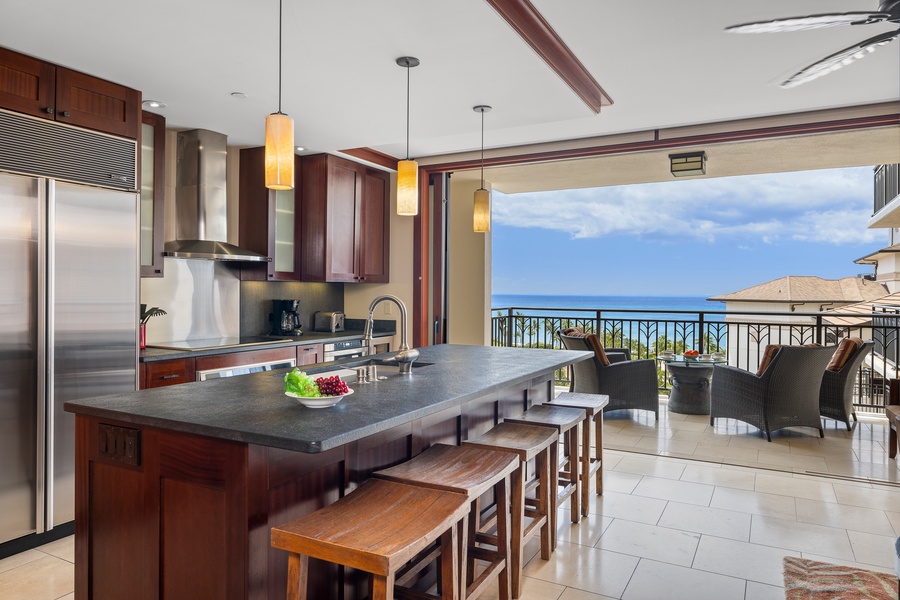 The fully equipped kitchen with bar seating and tropical views.