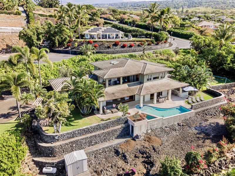 A stunning aerial view of the luxurious property surrounded by lush greenery and tropical vibes.