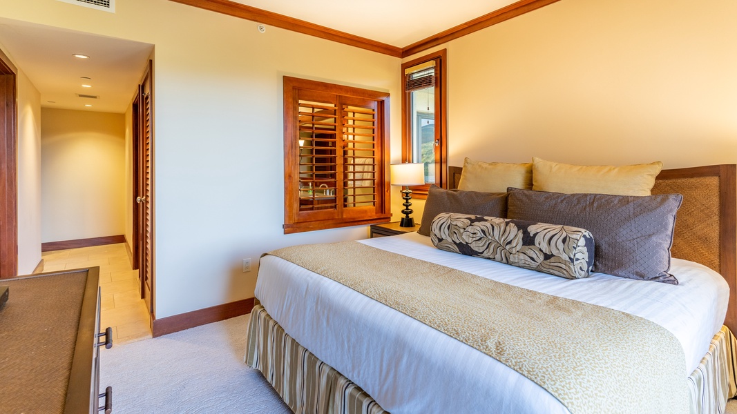 The primary guest bedroom with soft linens and night stand.