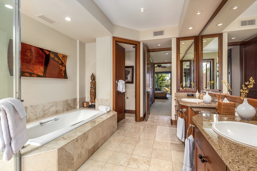 Primary bath with dual vanity, oval soaking tub, separate walk-in shower, private w/c and outdoor shower garden.