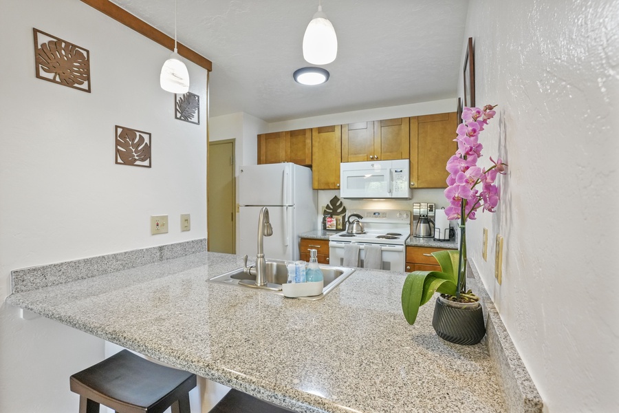 Kitchen area is open to the living area and has ample counter space for creating delicious meals