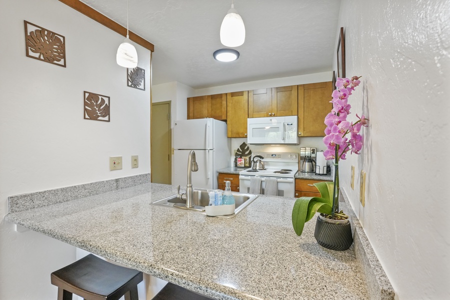 Kitchen area is open to the living area and has ample counter space for creating delicious meals