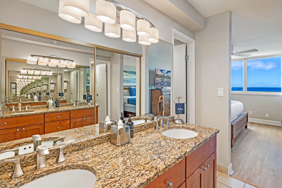 The bathroom features a double vanity with granite countertops, offering plenty of space for getting ready in comfort.