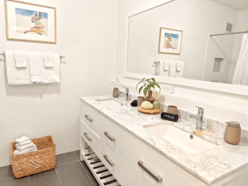 Pamper yourself in this spa-like bathroom with dual sinks, marble counters, and thoughtful touches that make your morning routine feel luxurious.