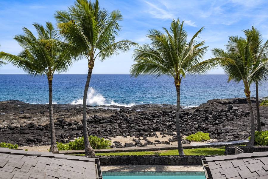 Enjoy stunning ocean views from the primary bedroom’s private lanai.