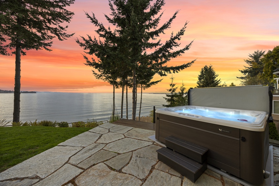 Private hot tub terrace overlooking the bay — unwind as the sun dips below the horizon.